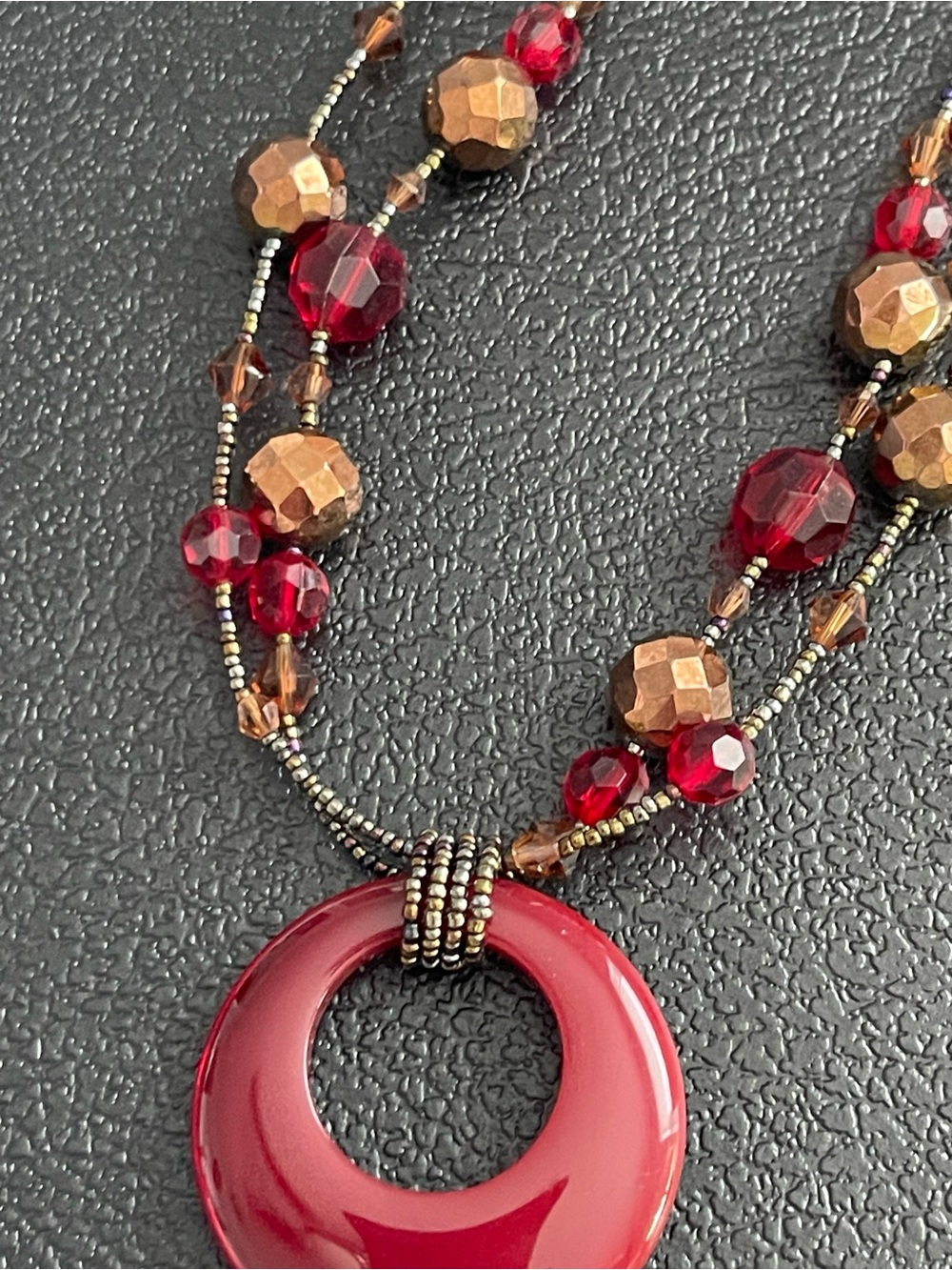 Lia Sophia woman’s Deep Red Donut Pendant Necklace with Bronze Accents